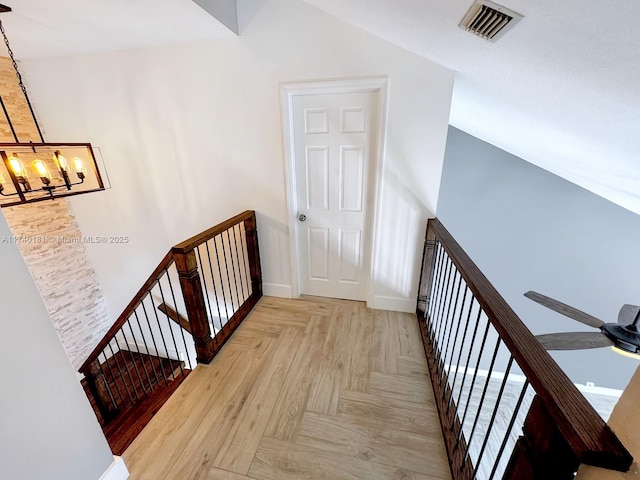 hall featuring a chandelier and light parquet flooring