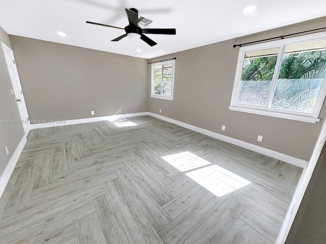 spare room with light parquet flooring and ceiling fan