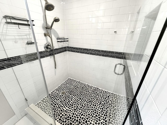 bathroom featuring a shower with door