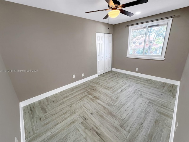 spare room with ceiling fan and light parquet flooring