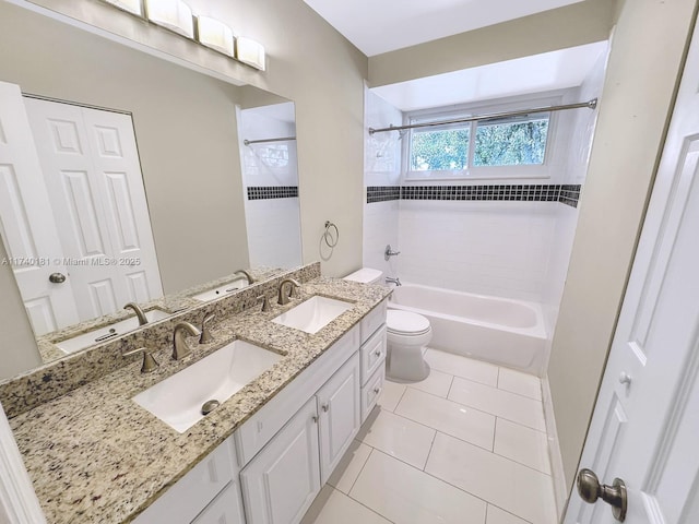 full bathroom with vanity, toilet, tiled shower / bath combo, and tile patterned flooring