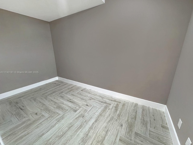 empty room with light parquet flooring