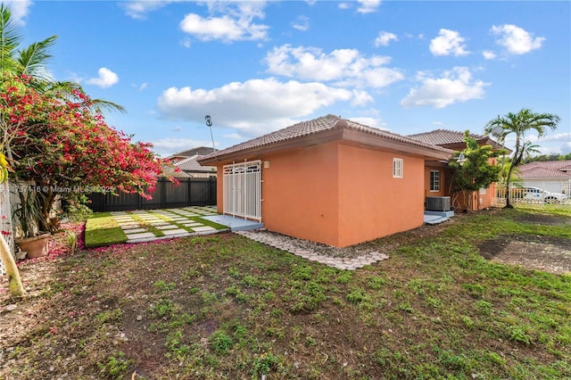 exterior space featuring central AC, a patio, and fence