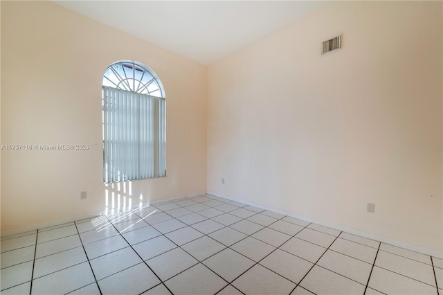 empty room featuring visible vents and light tile patterned flooring