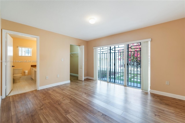 empty room with light wood-style floors and baseboards