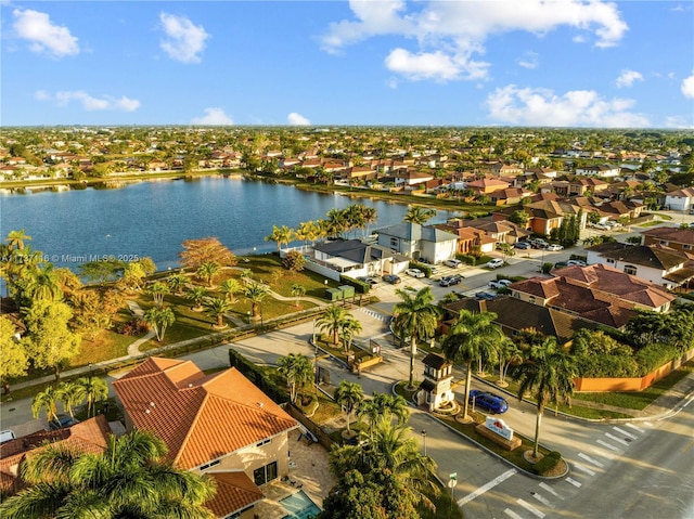 drone / aerial view featuring a water view and a residential view