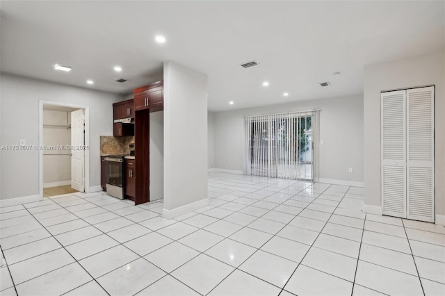 kitchen featuring tasteful backsplash, stainless steel electric stove, and light tile patterned floors