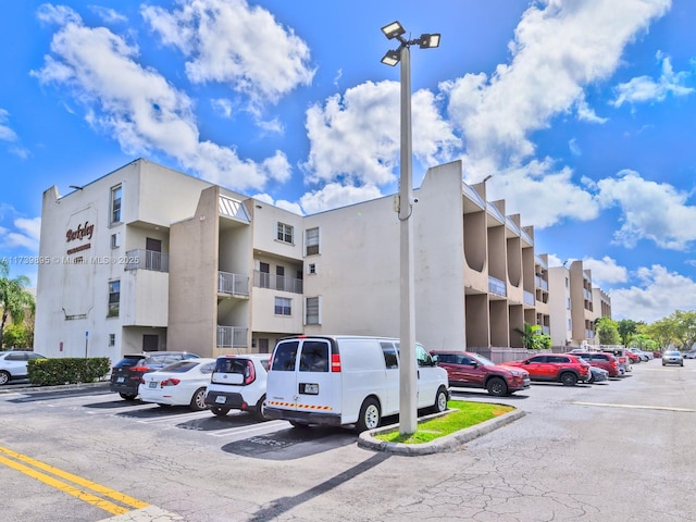 view of building exterior with uncovered parking