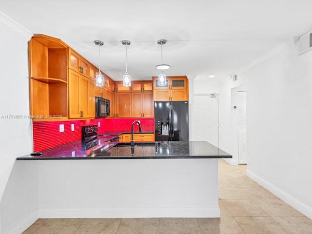 kitchen featuring black appliances, decorative backsplash, a sink, a peninsula, and glass insert cabinets