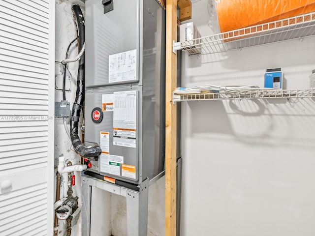 utility room featuring heating unit