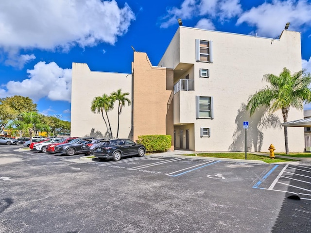 view of property featuring uncovered parking