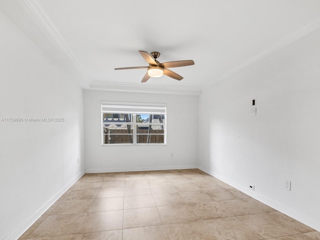 spare room featuring baseboards, crown molding, and ceiling fan