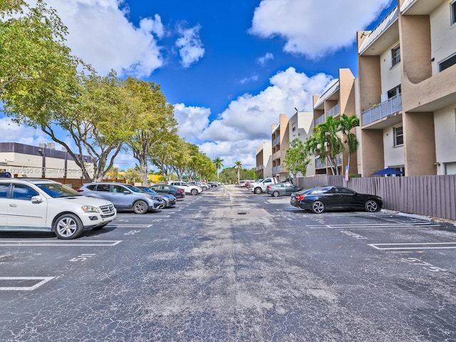 uncovered parking lot featuring a residential view