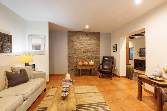 living room with visible vents, baseboards, and light tile patterned flooring