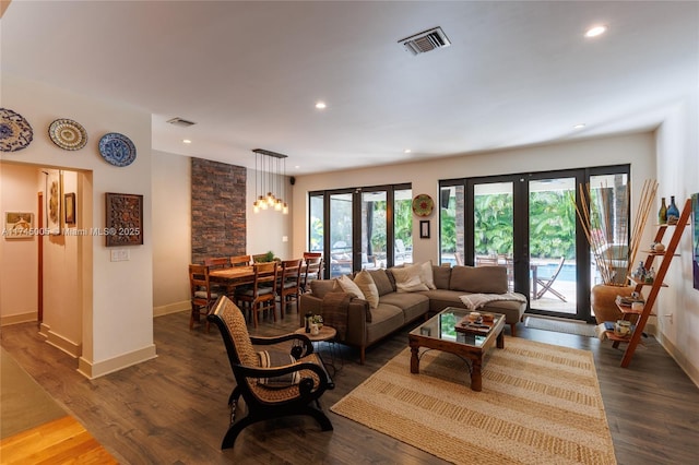 living room with dark wood-type flooring, recessed lighting, french doors, and visible vents