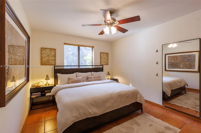 bedroom with a ceiling fan, baseboards, and light tile patterned floors