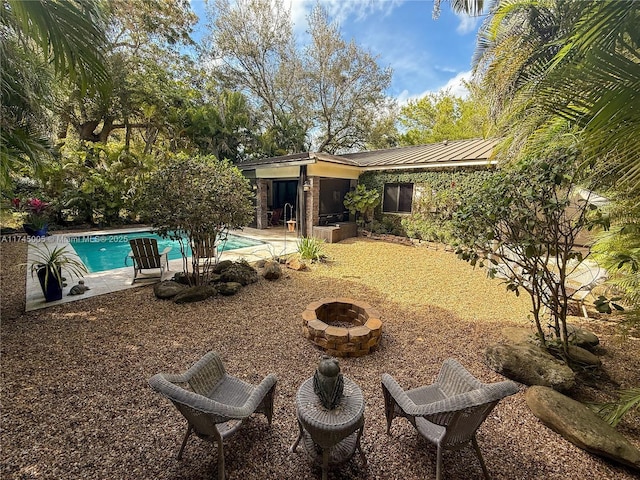 view of yard with an outdoor fire pit, a patio area, and an outdoor pool