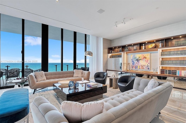 living area with floor to ceiling windows and a water view