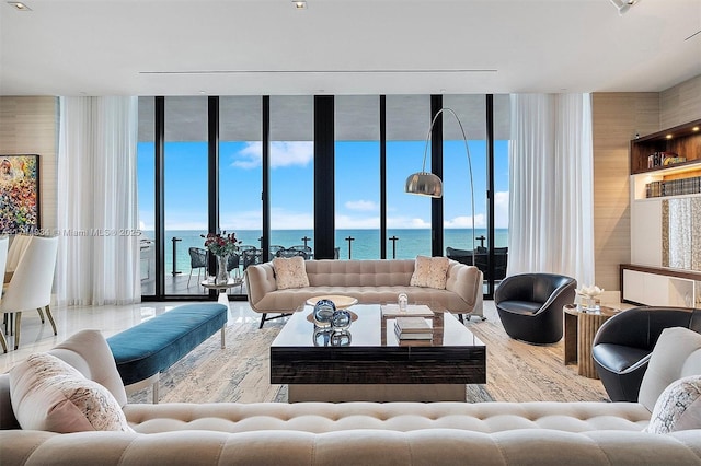 living room featuring a water view and a wall of windows