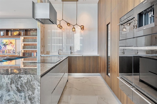 kitchen with decorative light fixtures, sink, dark stone countertops, wall chimney range hood, and black electric cooktop