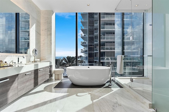 bathroom with floor to ceiling windows, shower with separate bathtub, and vanity