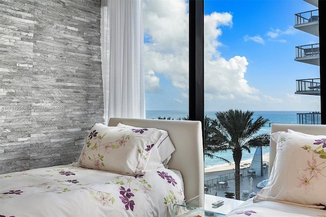 bedroom with a view of the beach and a water view