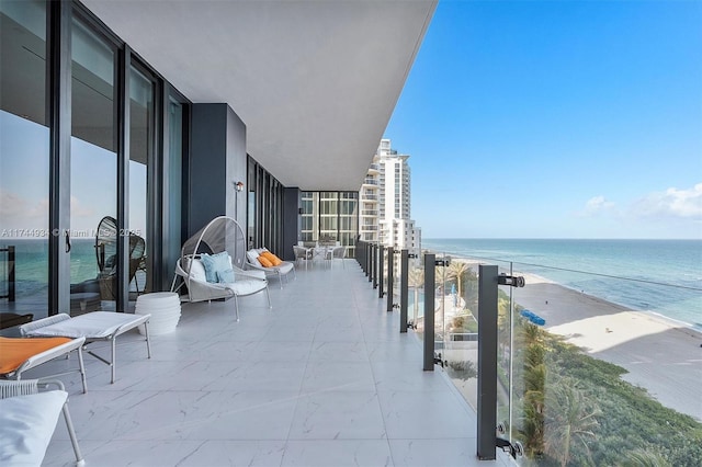 balcony with a water view and a beach view