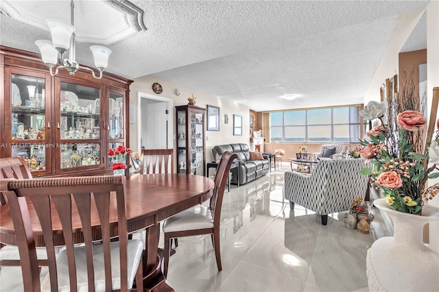 dining room with a textured ceiling and light tile patterned floors