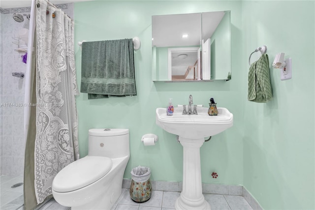 bathroom featuring tile patterned flooring, a shower with curtain, and toilet