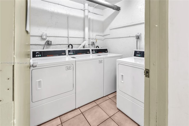 laundry area featuring separate washer and dryer and light tile patterned floors