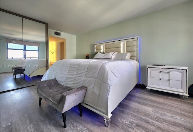 bedroom with visible vents and wood finished floors