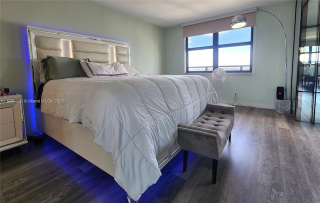 bedroom featuring dark wood-type flooring and baseboards