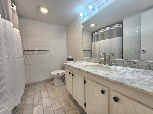 full bath with toilet, tile walls, vanity, and a shower with curtain
