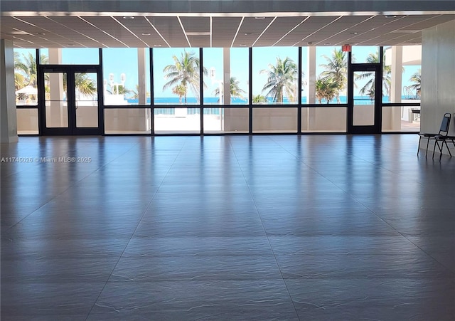 empty room with floor to ceiling windows and a healthy amount of sunlight
