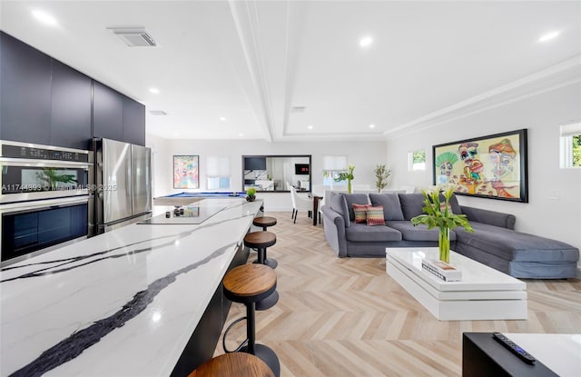 living room featuring recessed lighting, visible vents, and crown molding