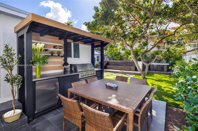 view of patio / terrace with outdoor dining space, an outdoor kitchen, a grill, and fence