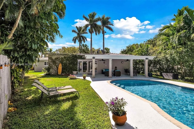 461 NE 115th St, Miami, FL 33161 - swimming pool featuring a ceiling fan, a lawn, and a patio