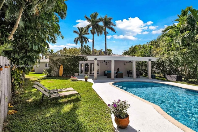 back of house with a yard, a patio, and ceiling fan