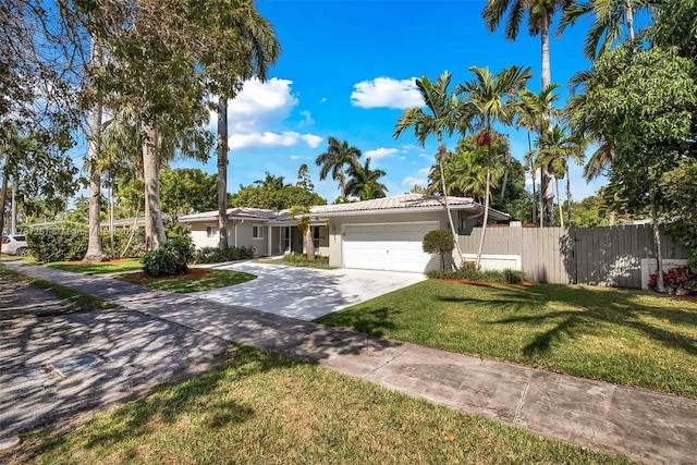 ranch-style house with a garage and a front lawn