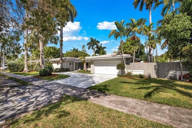 461 NE 115th St, Miami, FL 33161 - ranch-style home featuring an attached garage, concrete driveway, stucco siding, and a tiled roof