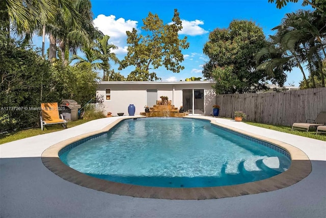 view of swimming pool with pool water feature