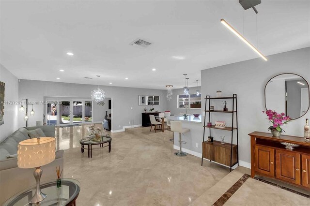 461 NE 115th St, Miami, FL 33161 - living room featuring a chandelier, recessed lighting, and baseboards