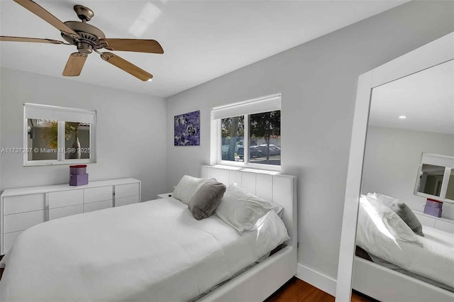 bedroom featuring ceiling fan and dark hardwood / wood-style floors