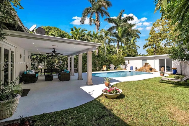 view of pool featuring an outdoor living space, a yard, a patio area, and ceiling fan