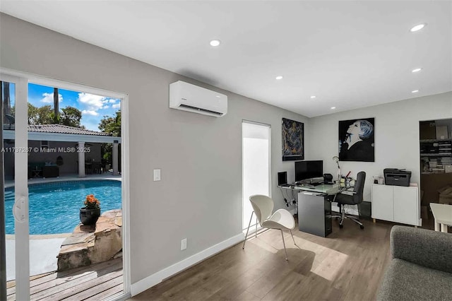 home office featuring wood-type flooring and an AC wall unit