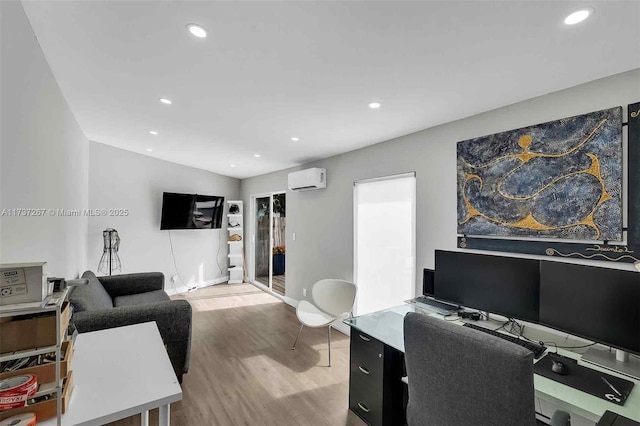 office area with light hardwood / wood-style flooring and a wall mounted AC