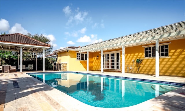 view of pool featuring a patio, a pergola, and french doors