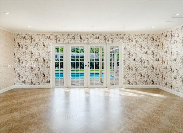 unfurnished room featuring french doors and a healthy amount of sunlight