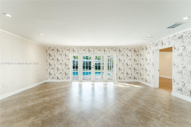 spare room featuring french doors and ornamental molding