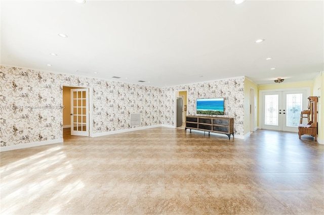 unfurnished living room featuring french doors